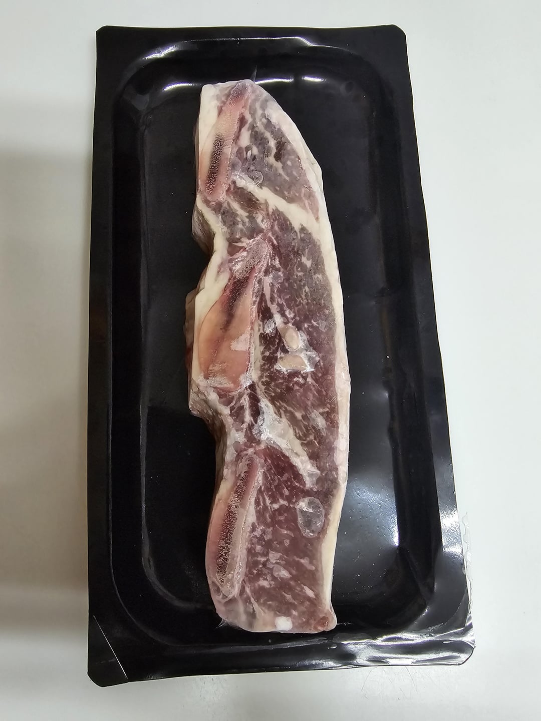 Clear Ribs Identification help. This was in my girlfriends freezer. She thinks it ...