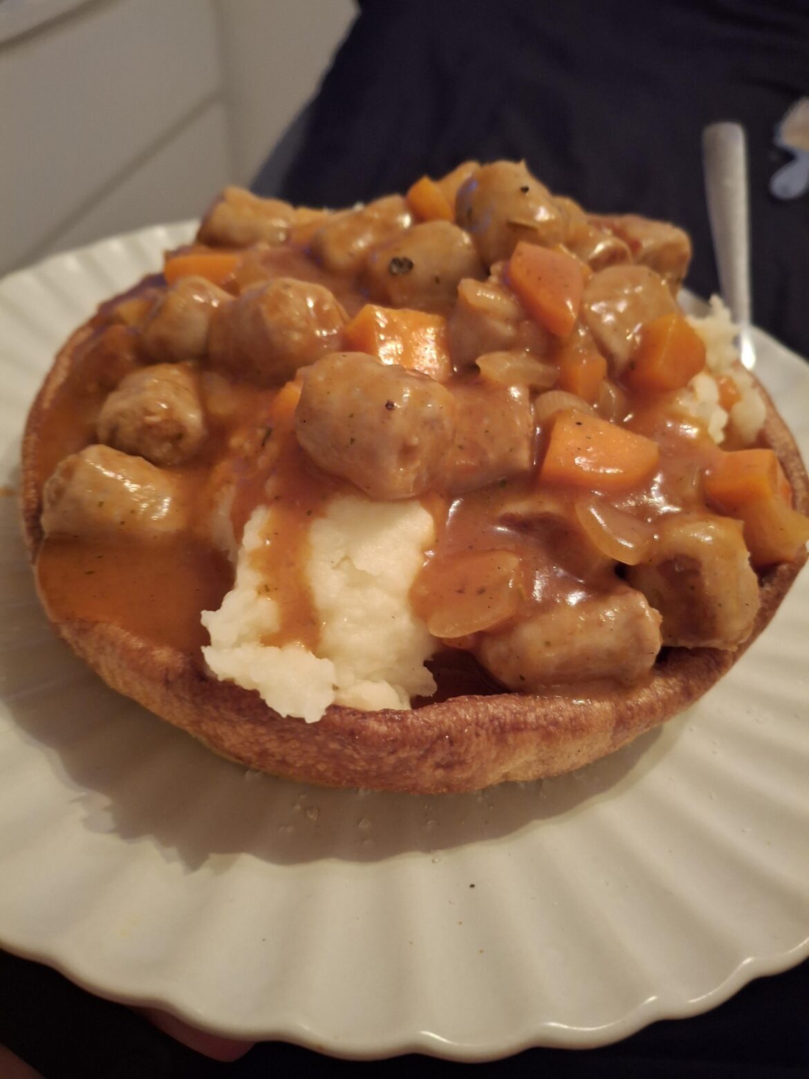 Sausage casserole and mash in a giant Yorkshire pudding