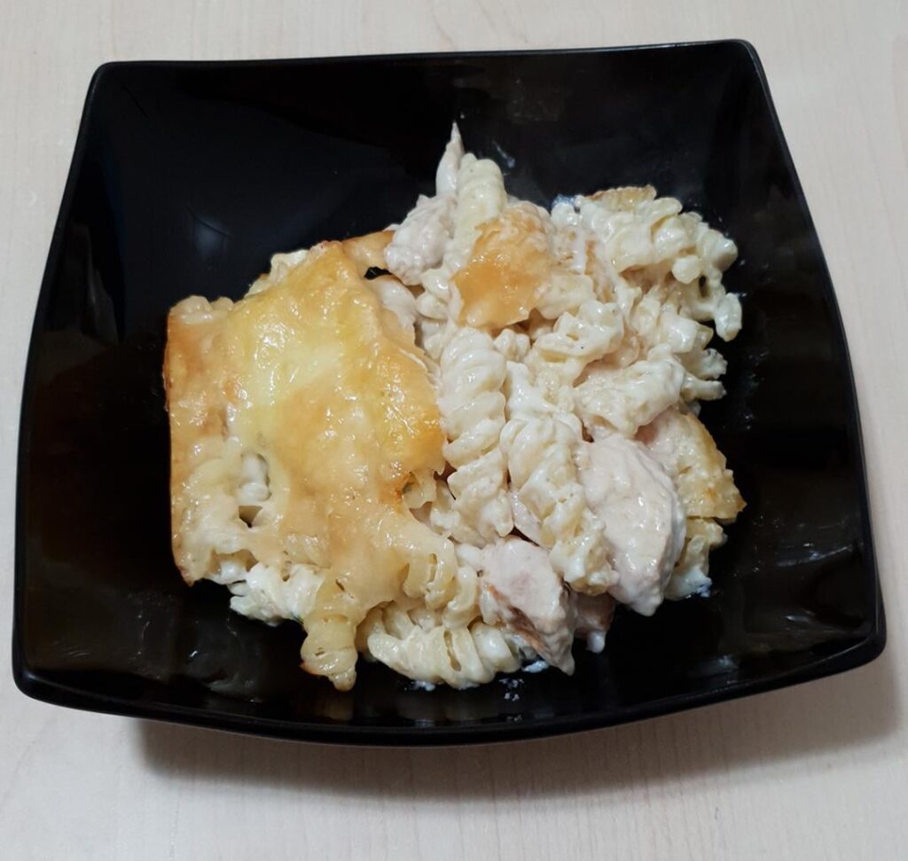 Chicken and pasta casserole with bechamel, Brie and Grana Padano