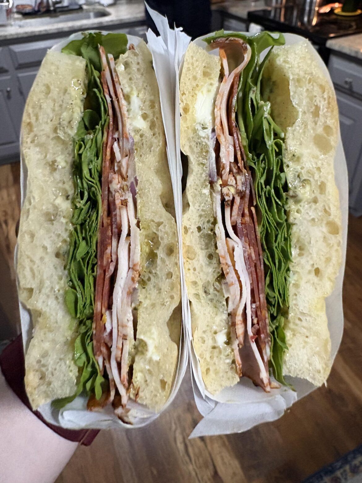 my husband’s lunch for work tomorrow- turkey & salami on homemade focaccia with pesto mayo, red onion, and arugula. (salt & vinegar kettle chips and ginger snap cookies not pictured)