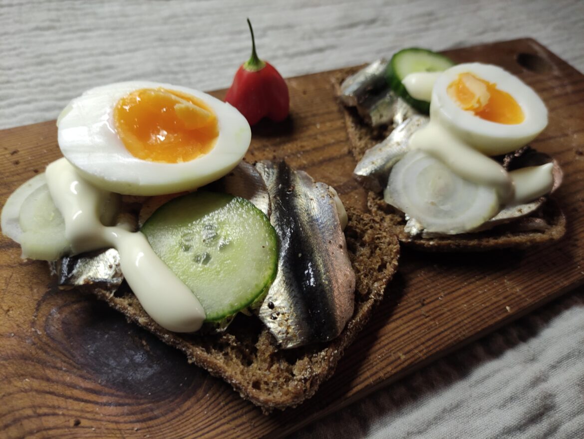 Black bread with anchovies and an egg on top. Usually this kind of sandwich has slices of hard-boiled egg, but mine was a little runny.