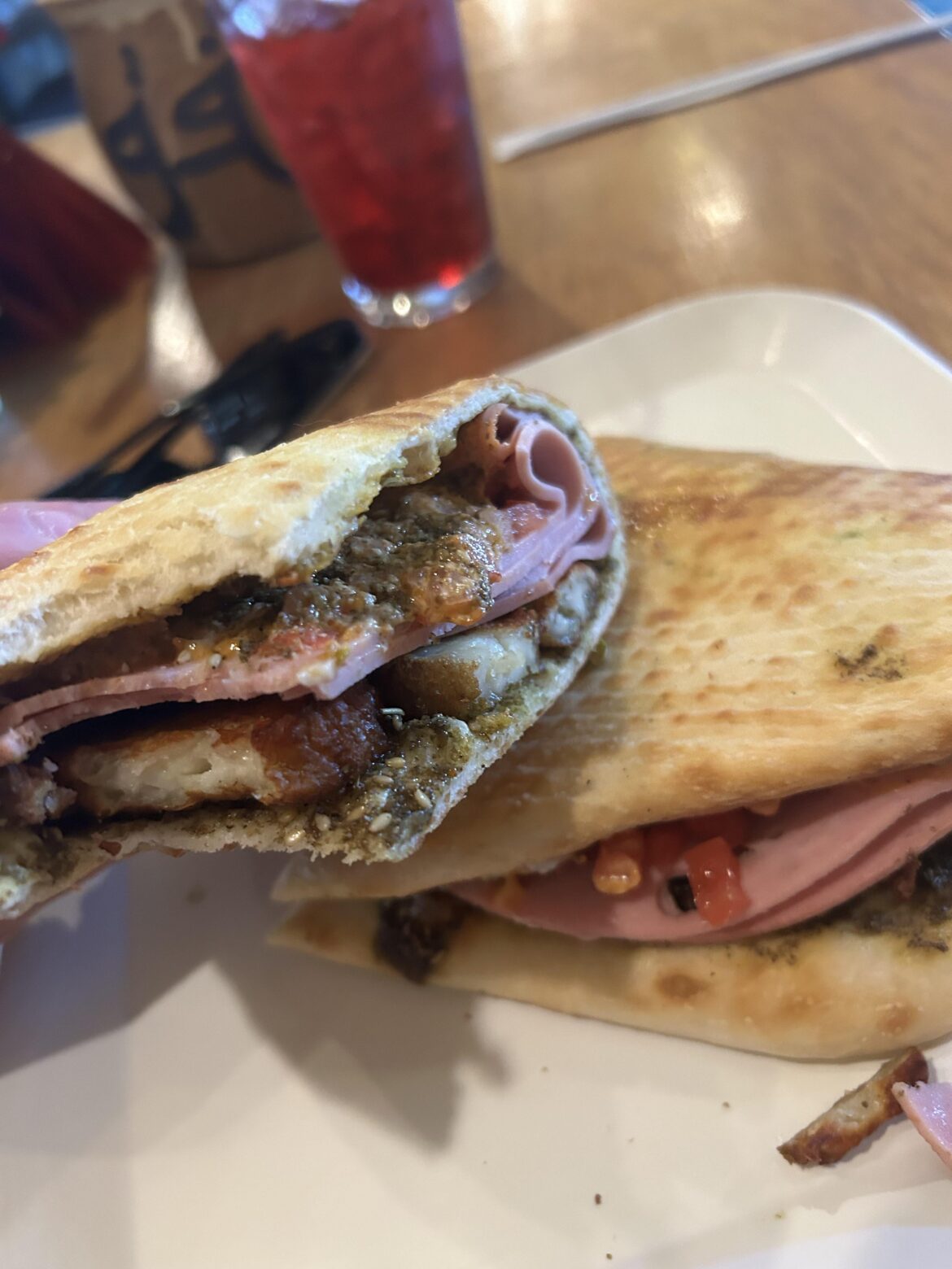 Mortadella, fried halloumi, spicy toum, onion, tomato, and spinach on za’atar manousheh