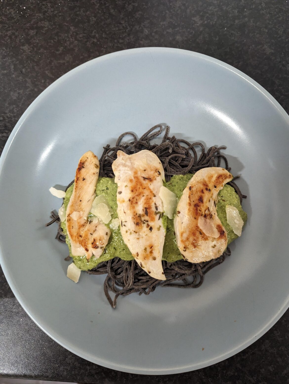 Homemade pesto and chicken on squid ink pasta