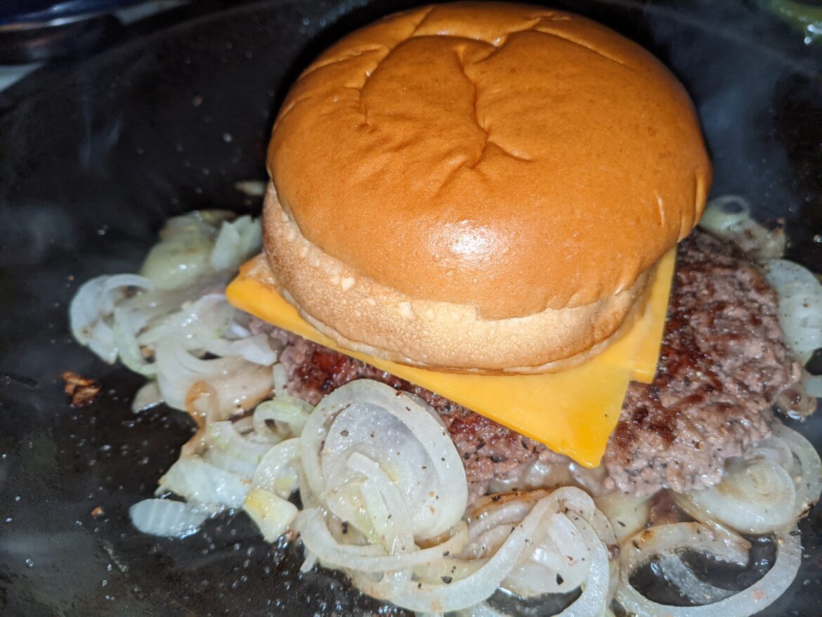 Onion cheeseburger in the making