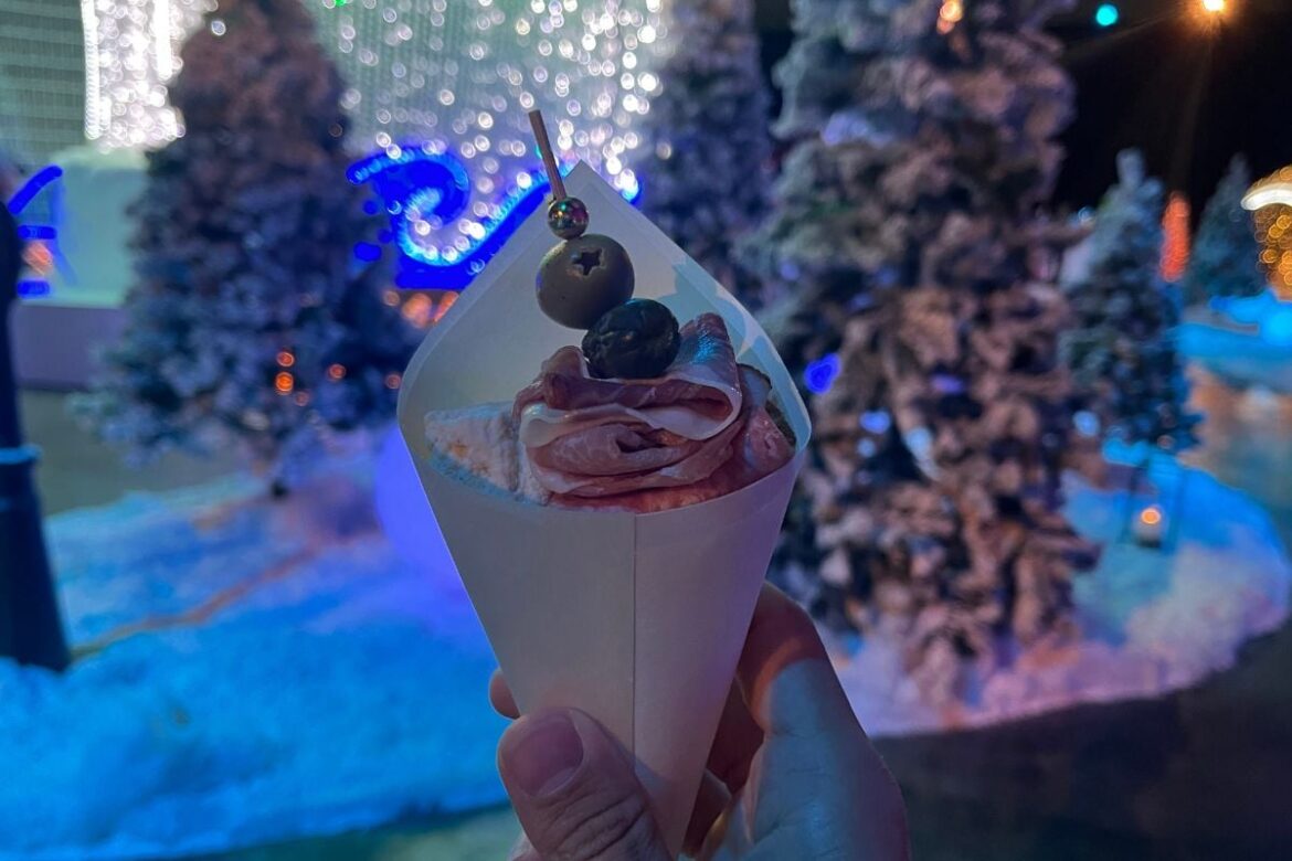 Charcuterie cup in front of christmas tree display