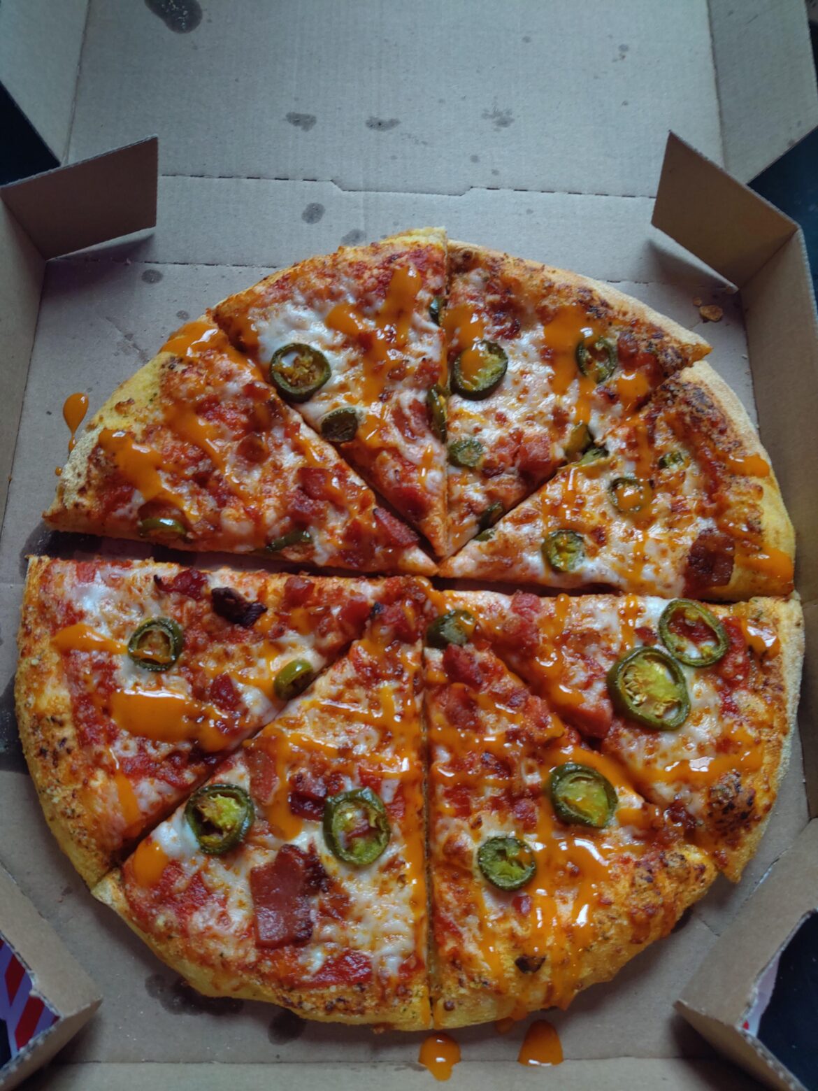 Bacon jalapeno pizza from Domino's with Melinda's ghost pepper sauce