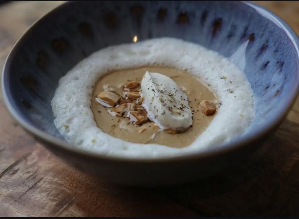 Frantzen's onion dish from slowly caramelized onions, shallots cream coffee oil, licorice whipped cream, and almond milk foam.