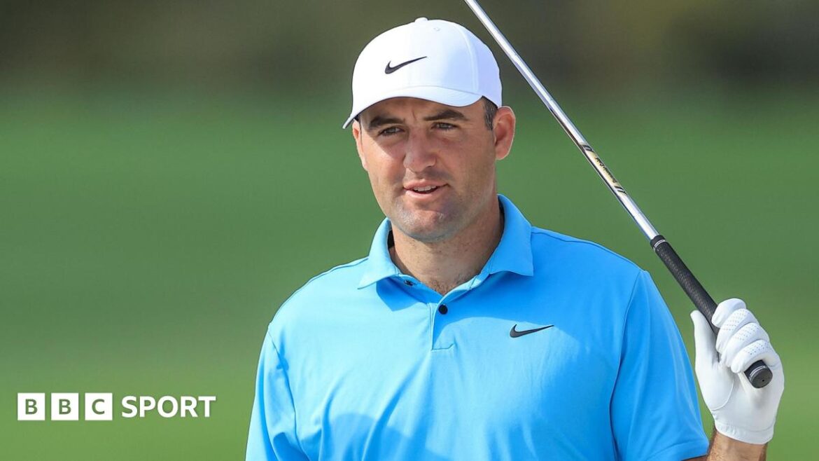 Scottie Scheffler holds an iron next to his head