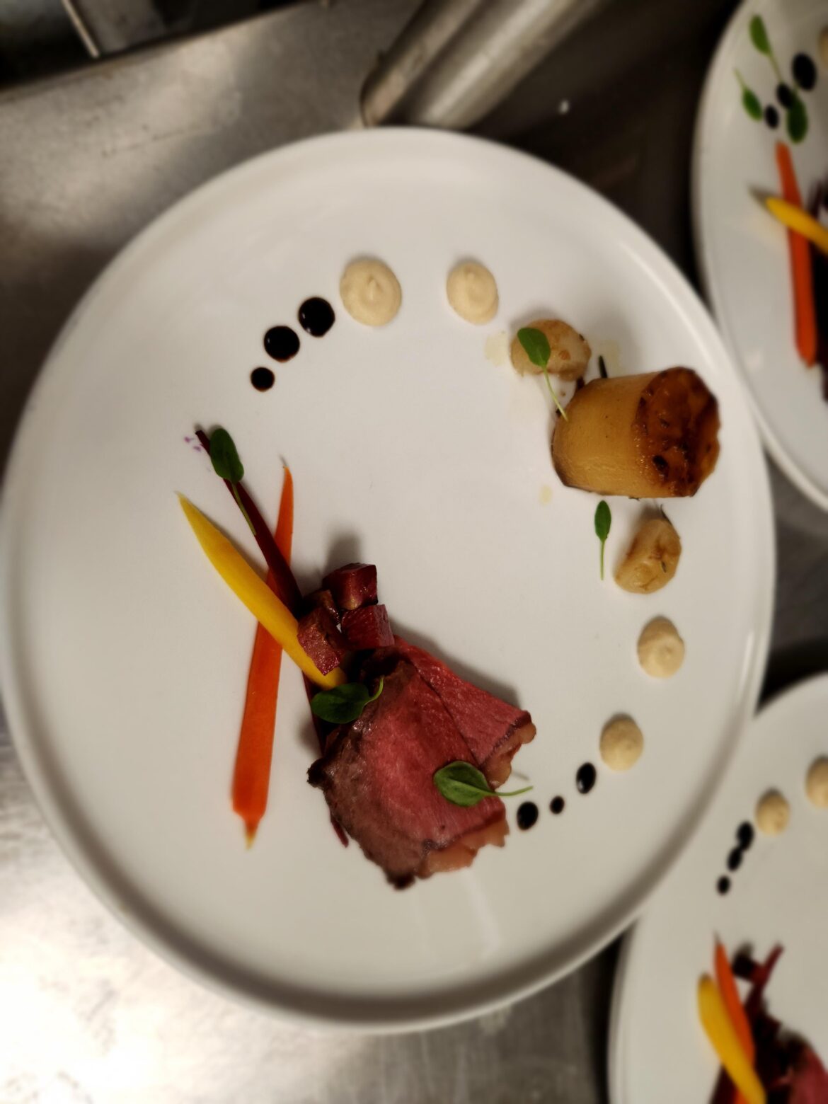 Wagyu NY Strip, pickled carrots, roasted radish, fondant potato, celeriac puree, black garlic emulsion
