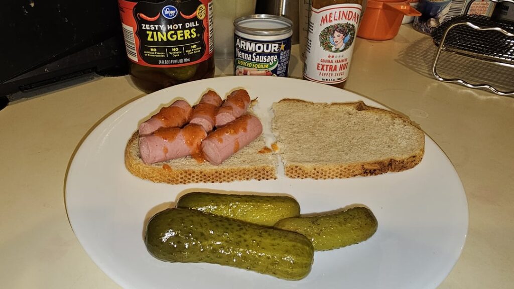 Hot 'n spicy mashed ween sammy with Melinda's and zesty dills