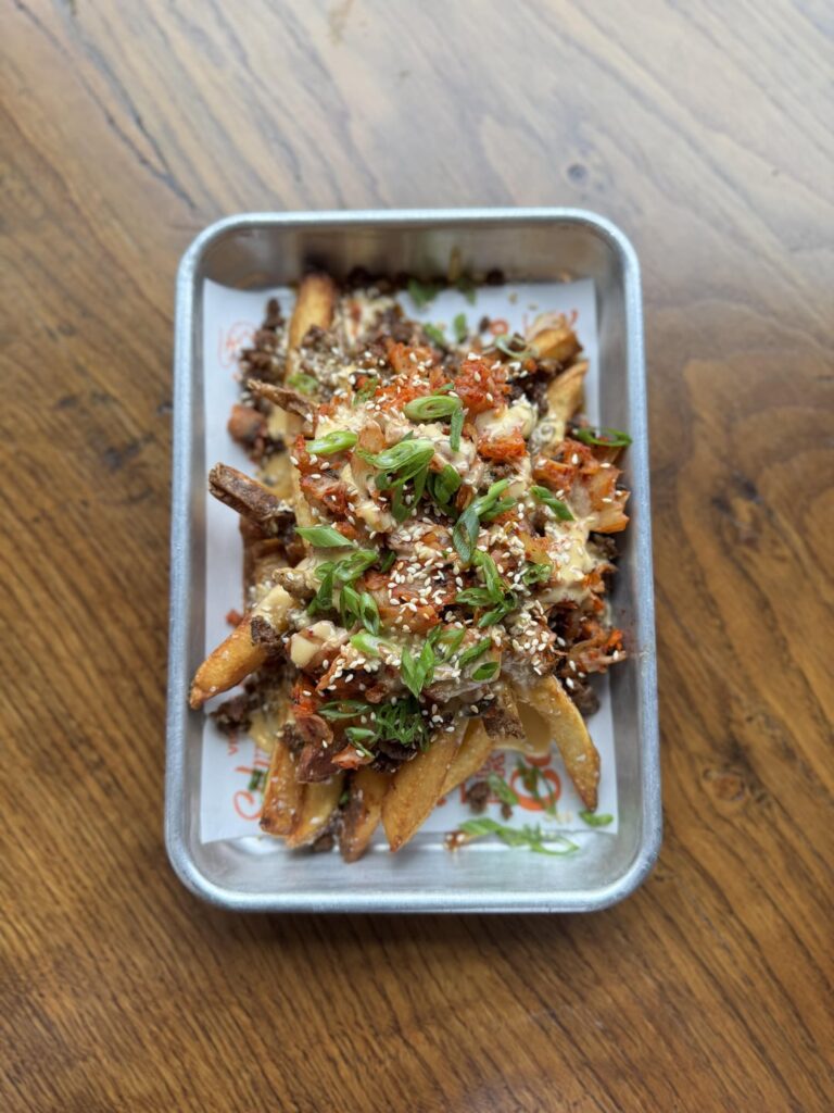 weekend special- kimchi fries: bulgogi style ground beef, hand cut fries, american cheese queso, sautéed kimchi, toasted sesame seeds, green onions