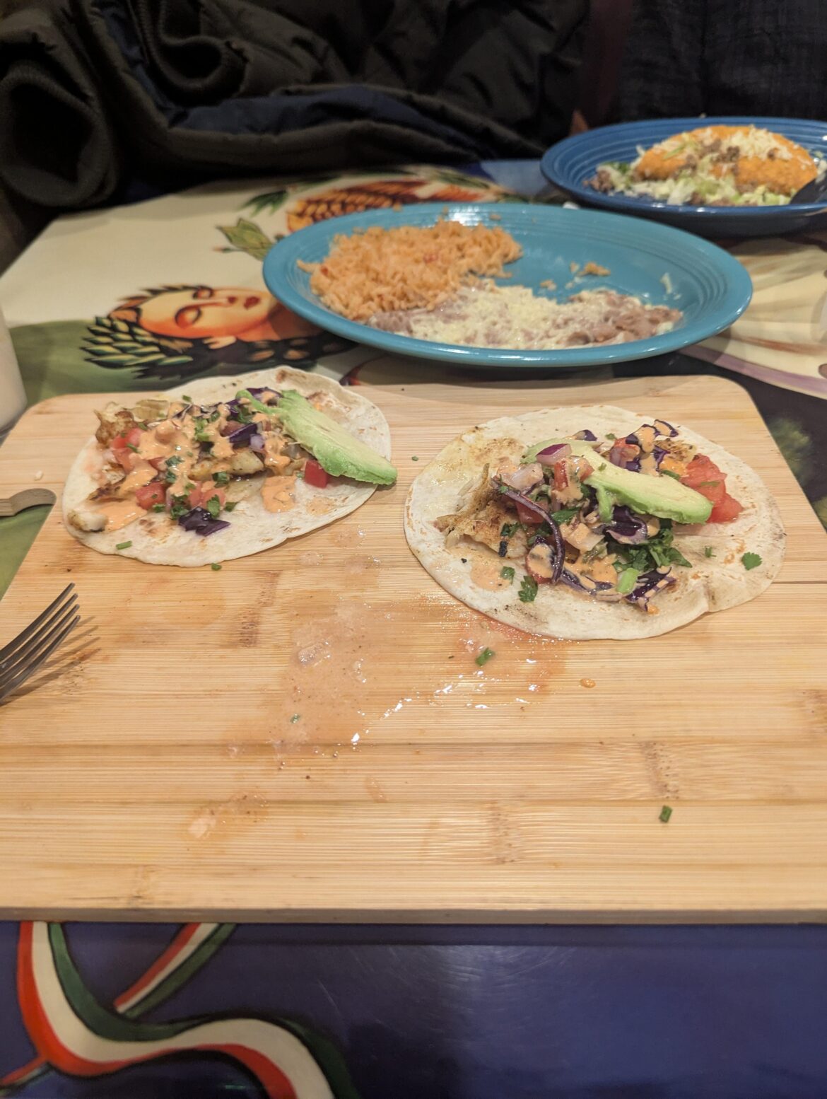 Fish tacos on a broken cutting board.