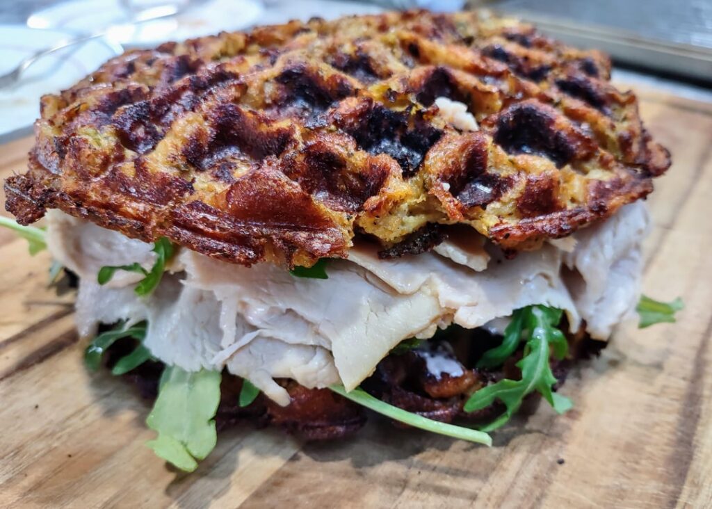 Turkey Waffle Sandwich - Baked Turkey, (Bread) Stuffing Waffle, Arugula, and Cranberry-Orange Mayo.