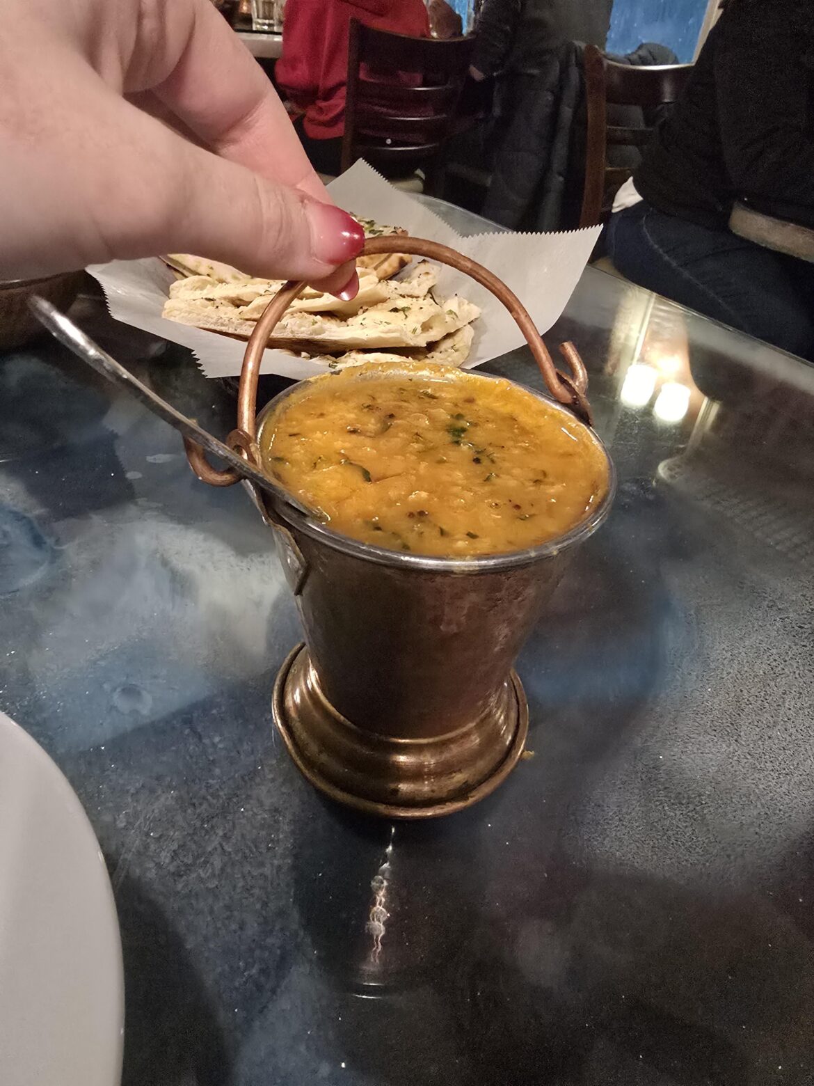 Spiced lentils served in a tin bucket