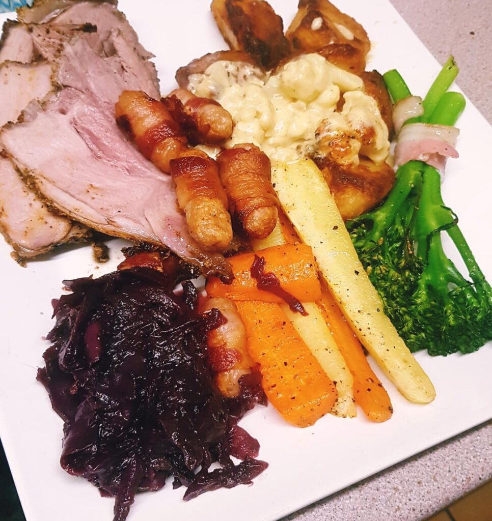(A little late) Herb Crusted Leg of Lamb (cooked to a perfect 130f M/R), Rosemary Garlic Potatoes, Mustard Cauli Cheese, Honey Carrots and Parsnips, Braised Wine Red Cabbage, Pigs in Smokey Blankets, Buttery Tenderstems and a Red Wine Gravy.