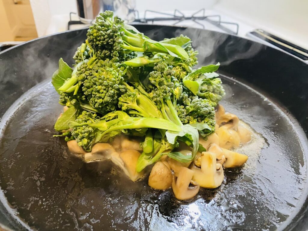 Spicy Sichuan mushrooms, broccolini, and tofu, with flat soup noodles.