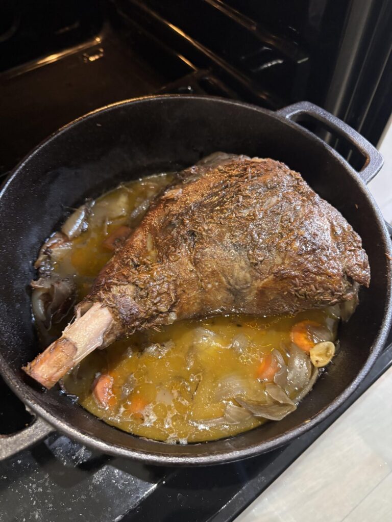 Slow cooked lamb leg with onions, garlic, and carrots, served with a Heineken gravy.