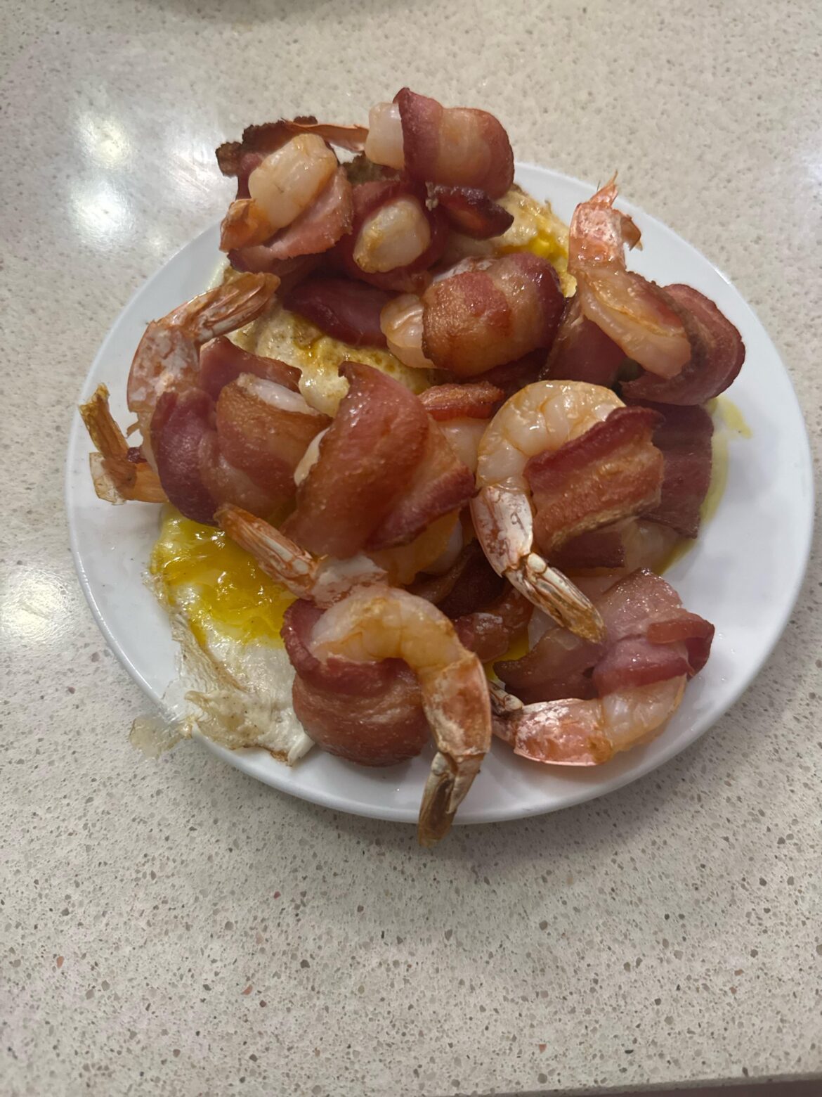 Bacon wrapped around shrimp and eggs