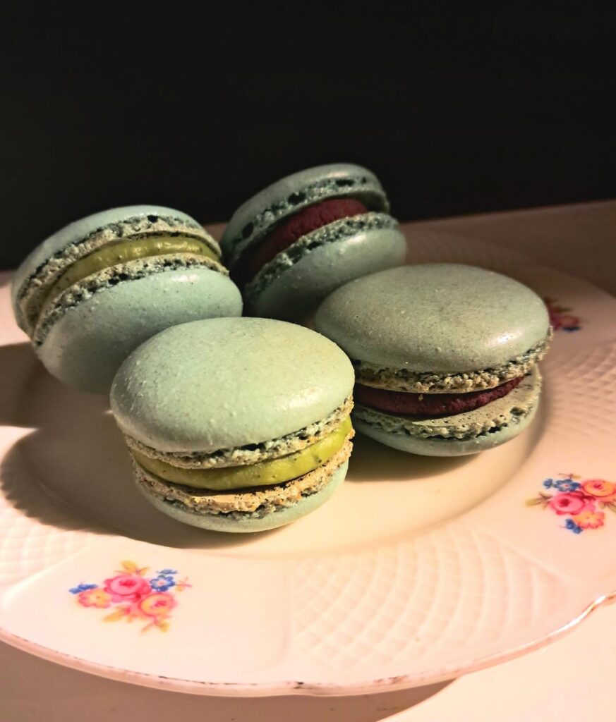 Macarons with matcha-white chocolate ganache filling (left) and dark chocolate-allspice ganache filling (right)