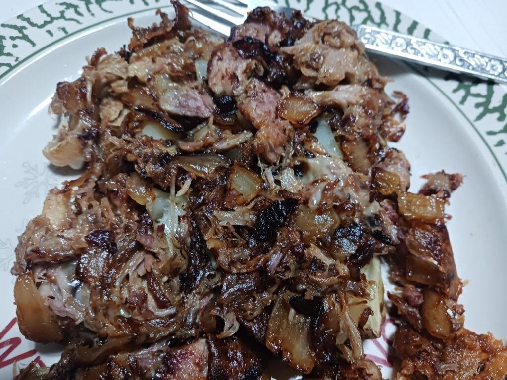 Baked potatoes with onions, pork, and smoked sharp cheddar