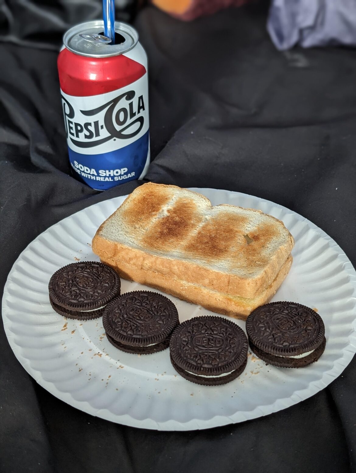 Depression Lunch or Hot Girl Dinner: a Pepsi Cola made with real sugar, toast with salted butter, and four oreos on a paper plate. Served on a bed so I could hide from some terrible, terrible people in my apartment.