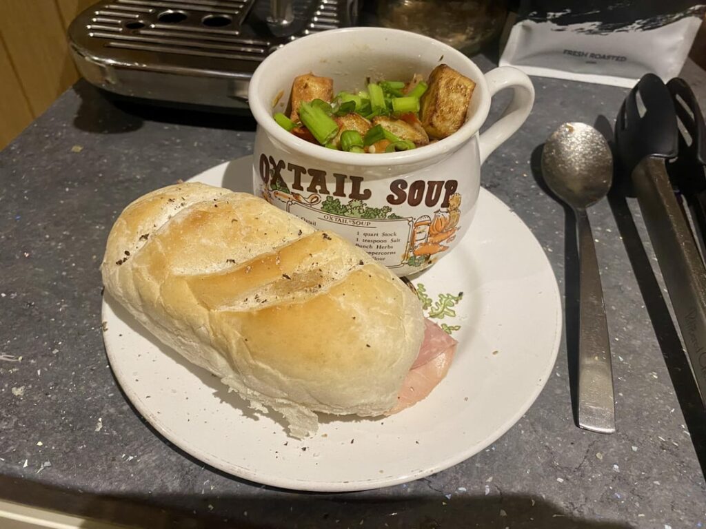 Stew mixed with air fried short chips and a ham and stew sandwich