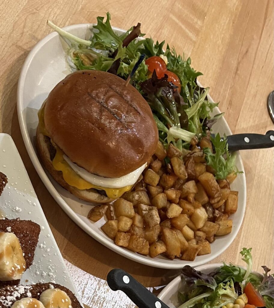 how many calories? burger with egg, house salad, and potatoes i had half of - from popping yolk cafe