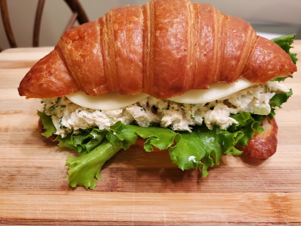 Homemade chicken salad sandwich on toasted croissant