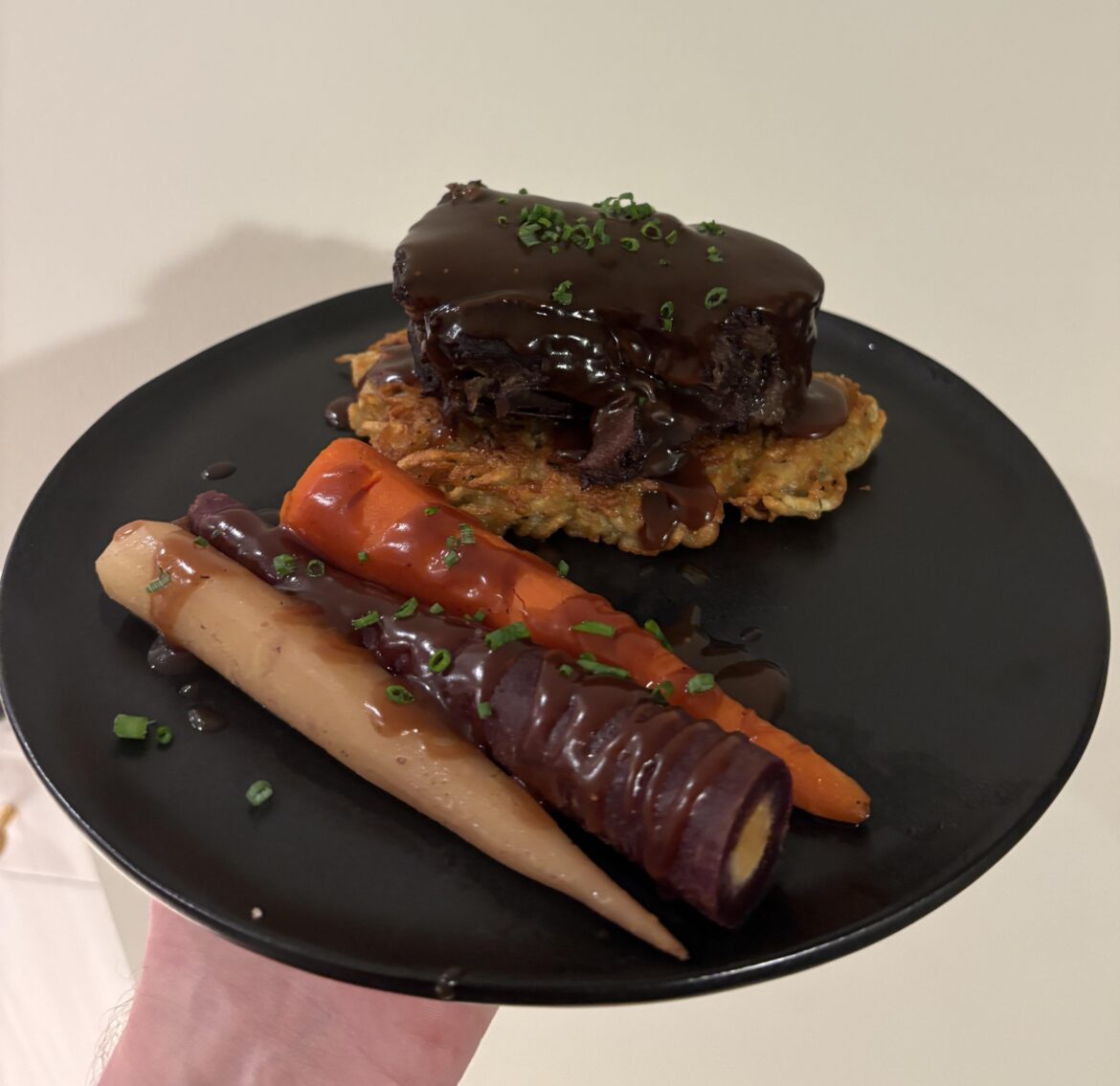 Red wine braised short rib on a latke with rainbow carrots