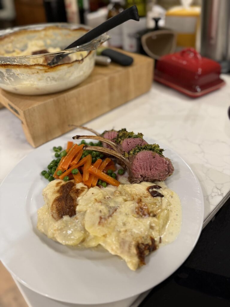 Crusted rack of lamb, dauphinoise, buttered carrots and peas