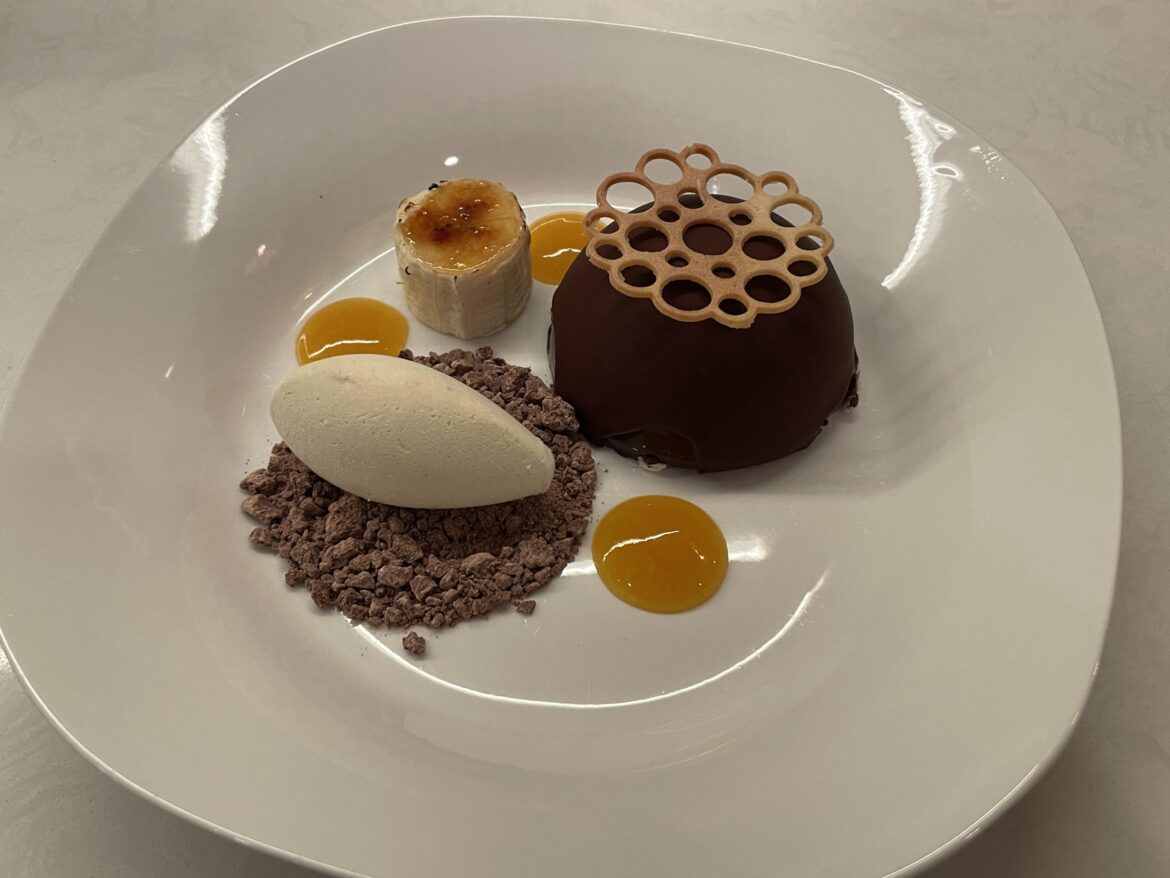 Banana, Crispy Praline and Vanilla Mousse Entremet, Bitter Chocolate Shell, Roasted Banana Ice Cream, Chocolate Soil, Passionfruit-Apricot Gel, Brûlée Banana
