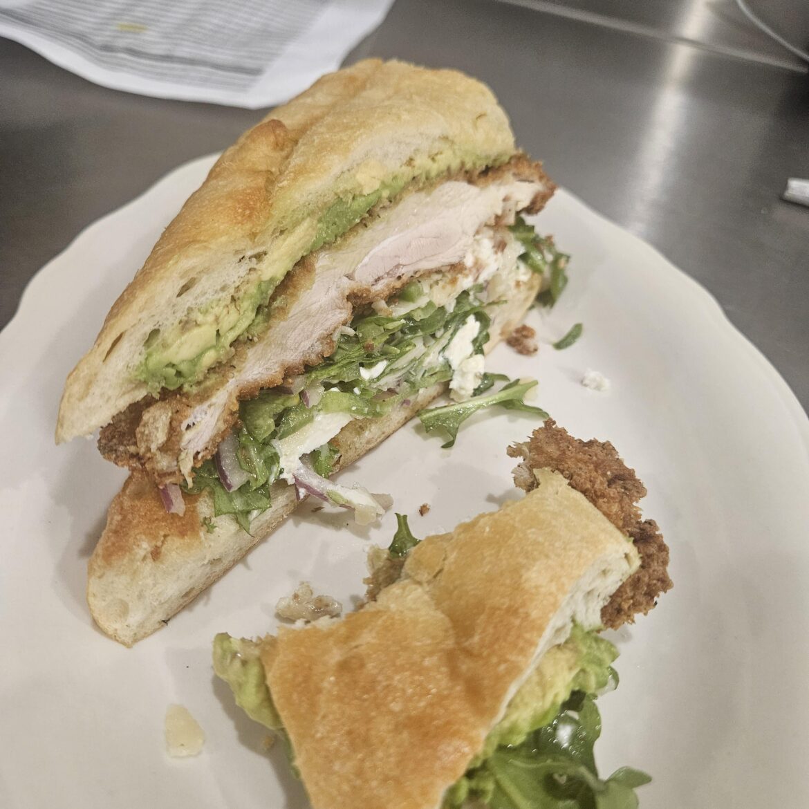 Baguette, smashed avocado, crispy chicken thigh, feta, shaved Parm, arugula, red onion, jalepeno, basil vinaigrette.