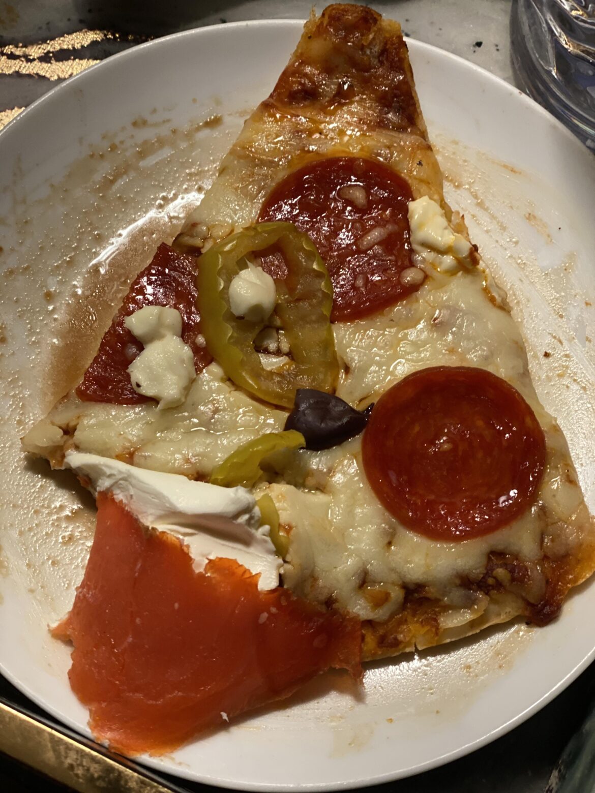 Salmon and cream cheese on the lower left corner. Liquid underneath is balsamic. Dark spot in the middle is an olive because… I’m fancy.