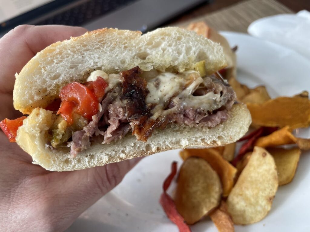 Prime ribeye Italian cheesesteak with provolone and hot cherry peppers on Bastone bread