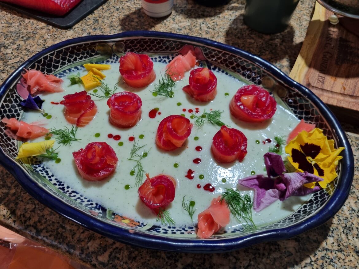 A Dream of Spring - Beet-cured salmon with edible flowers and pickled ginger, on a cream of coconut sauce