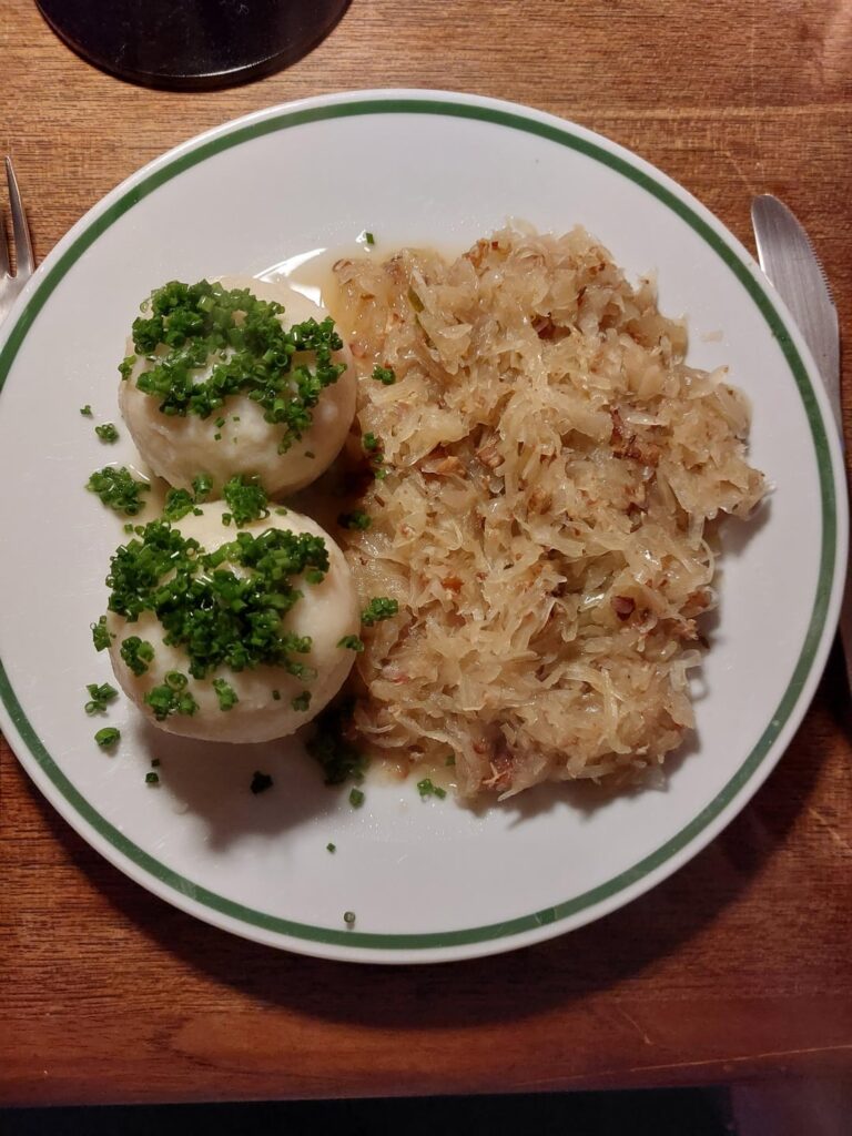 Crackling filled potato dumplings with Sauerkraut.