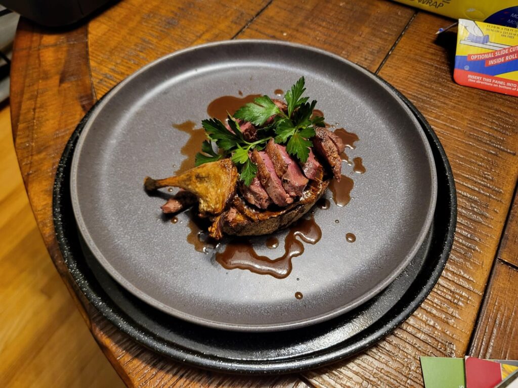 Open-faced sandwich: Half a pintail on a crouton with duck liver pate, winecap mushroom, and blood orange-bourbon sauce