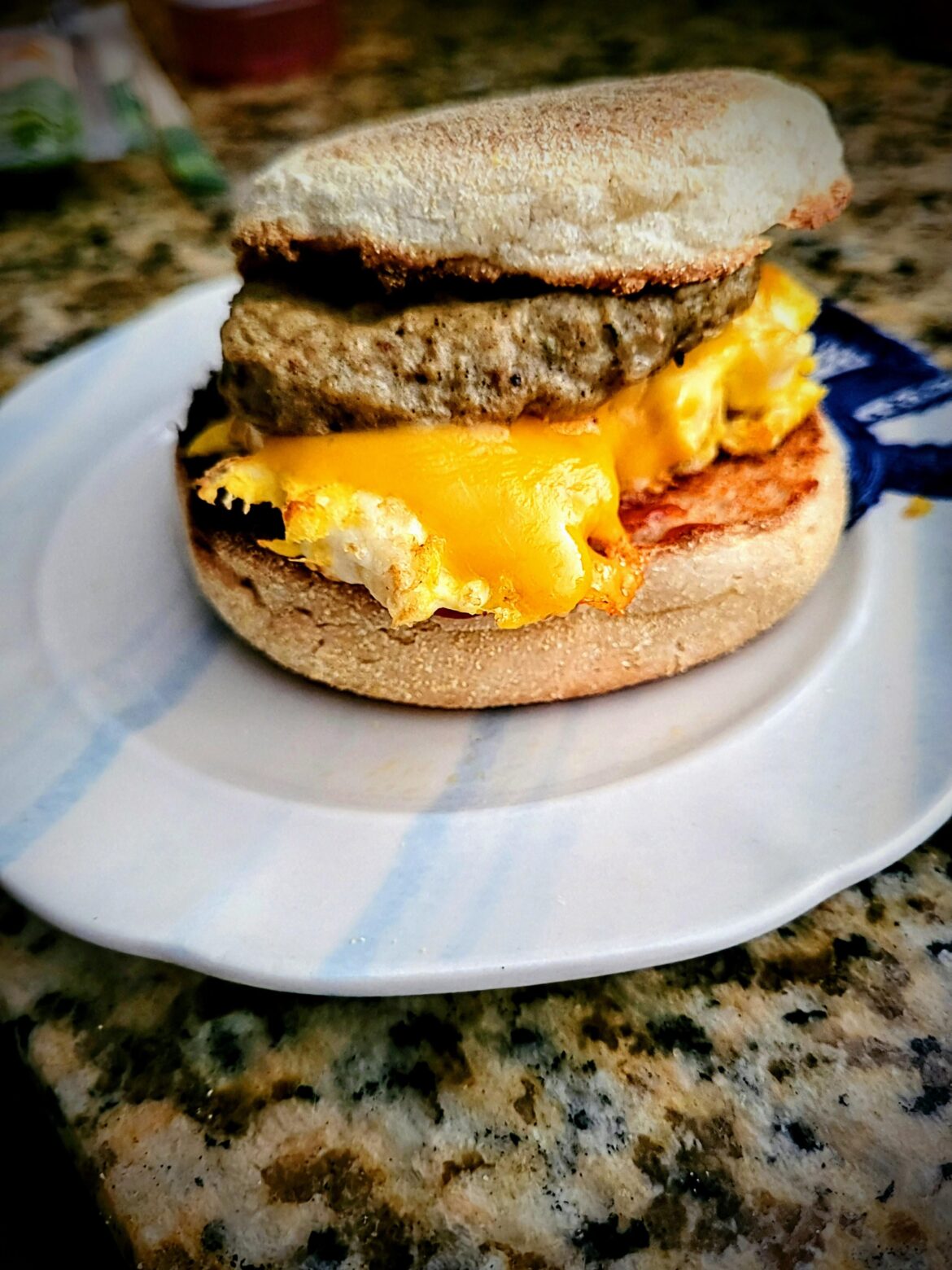 Trader Joe's Chicken sausage, sharp cheddar & egg on a toasted English muffin (with ketchup)