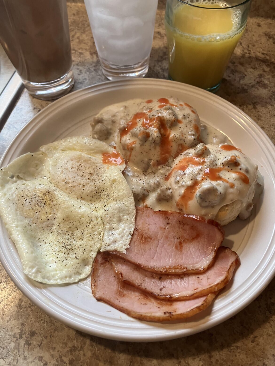 Biscuits and gravy with a couple over sleazy eggs