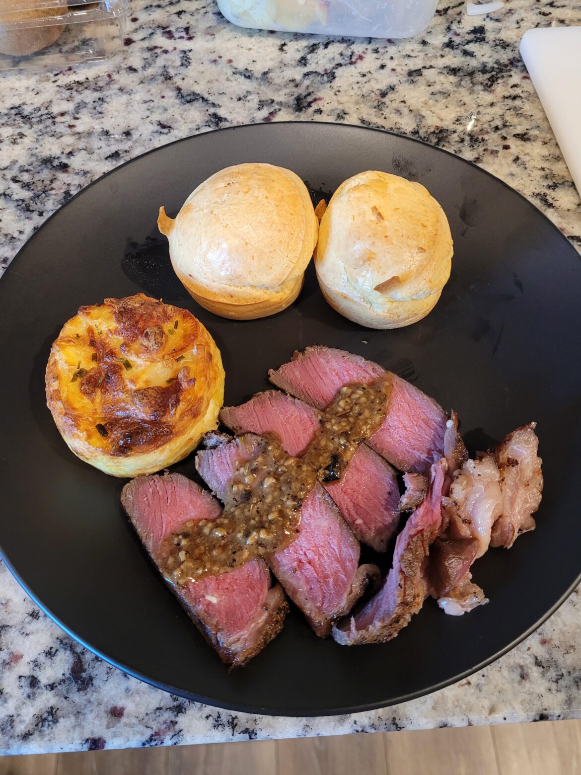 Ribeye w/ pan sauce, potato au gratin, Brazilian chez bread