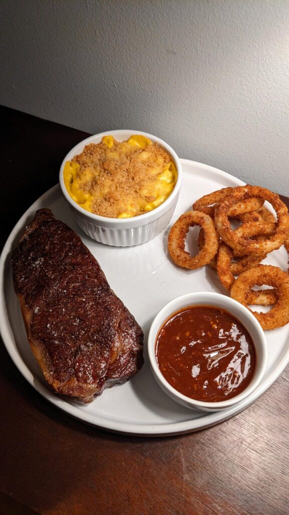 Prime Strip, Baked Mac & Cheese, Onion Rings