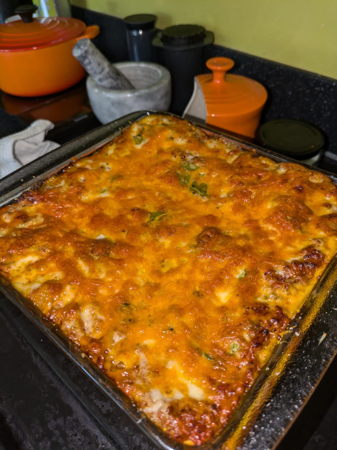 Made Carmella's lasagne from The Sopranos, with sweet sausage in little pieces and a layer of basil leaves underneath the cheese.