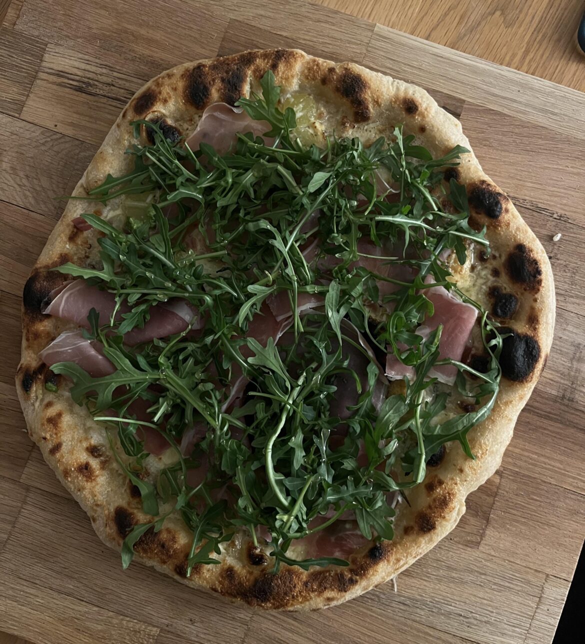 Poolish dough with grapes, Gorgonzola, prosciutto, arugula, hot honey