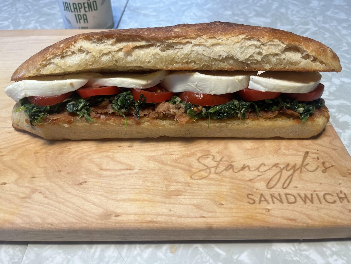 N’duja (an Italian spread made from Calabrese salami and hot and sweet peppers), sautéed spinach and garlic, tomatoes, olive oil, and fresh moz, on a grilled baguette.