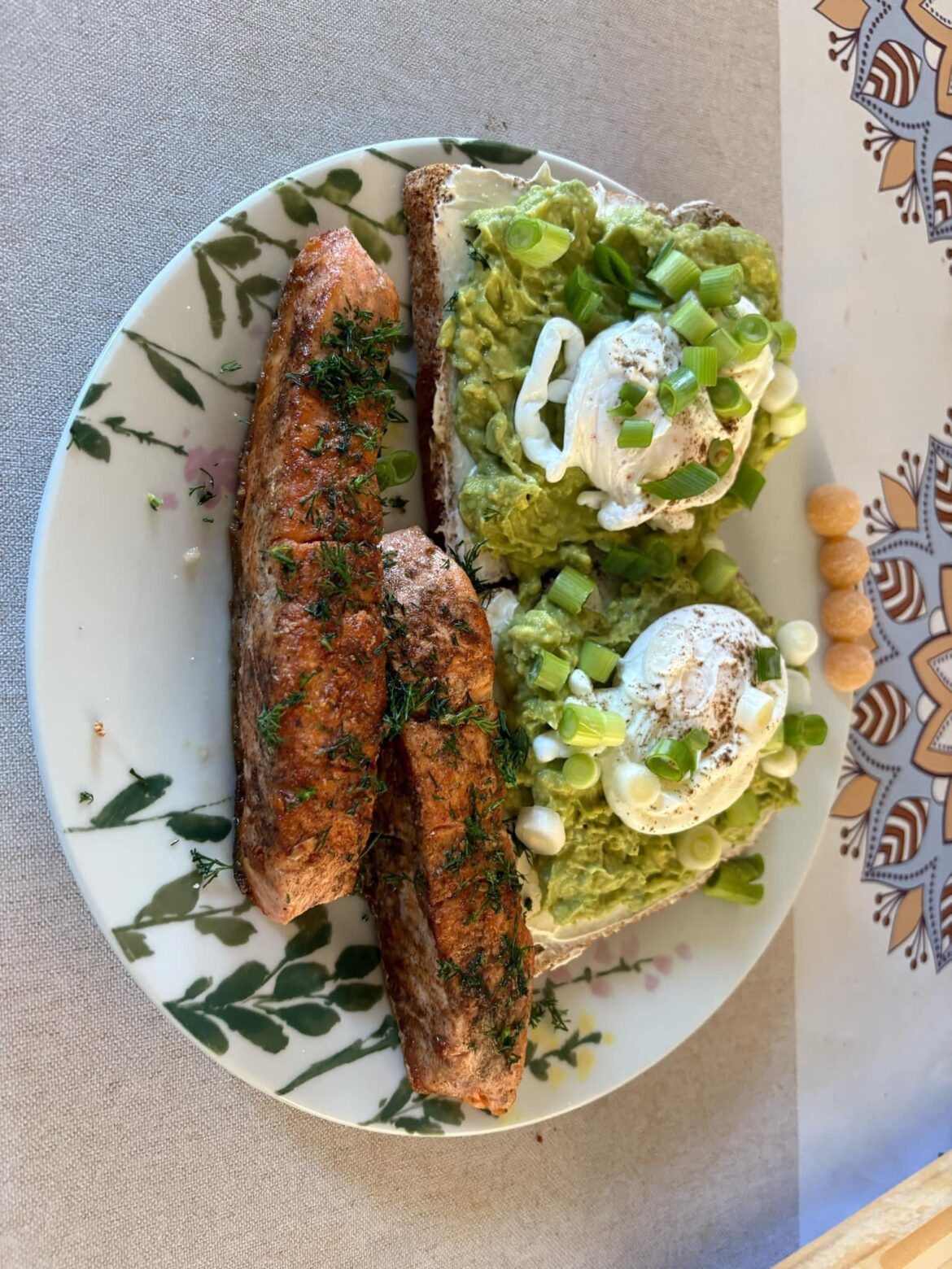 Pan fried salmon with poached eggs on cream cheese and avocado toast