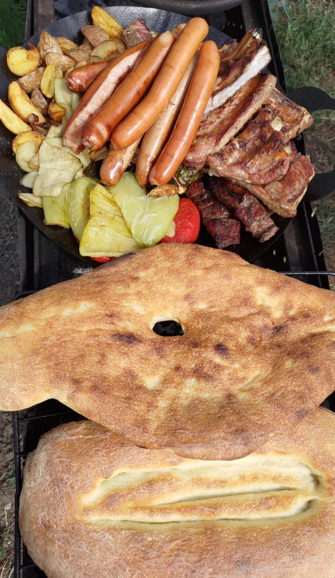 Shashlik, sausages, ribs, vegetables on coals