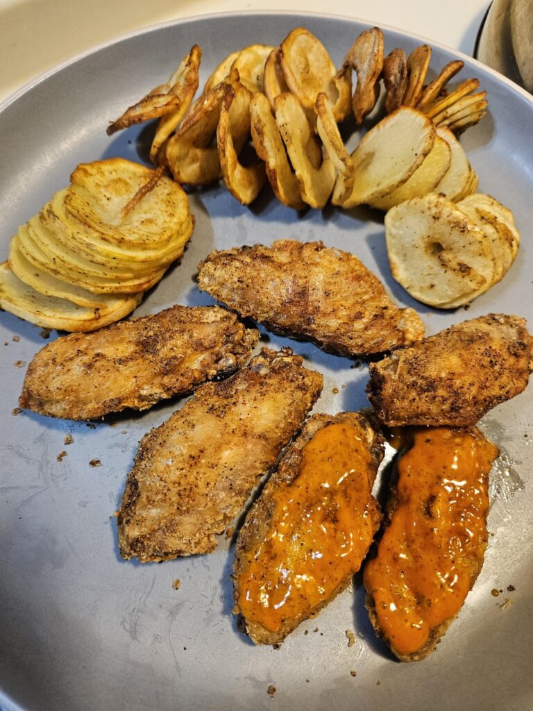 Air fryer Cajun wings with spiral potatoes