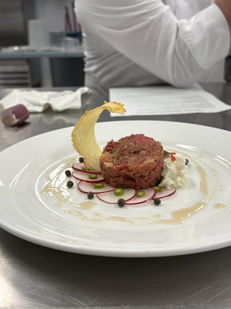 app: kimchi beef tare tare with parmesan crisp - entree: duck, gnocchi, roasted tomatoes and shallots - dessert: matcha & sakura crepe cake with layered strawberries and chocolate work