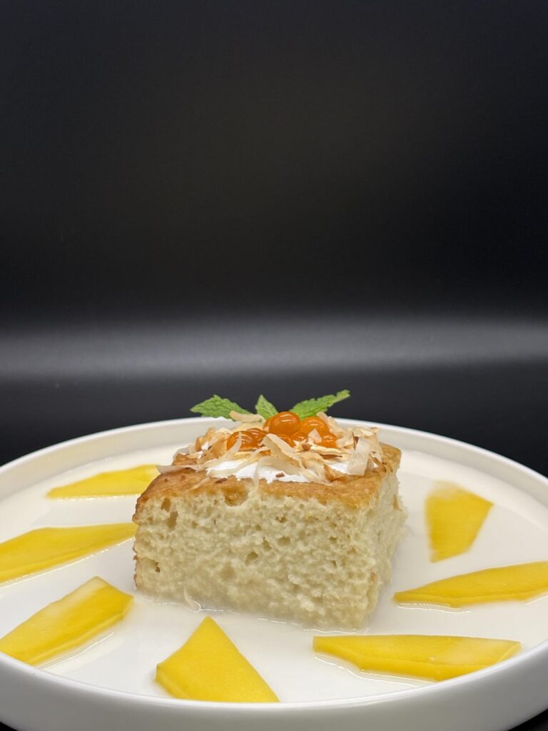 Coconut Tres Leches with Popping Mango Boba, Fresh Mango Slices, and a toasted marshmallow cream