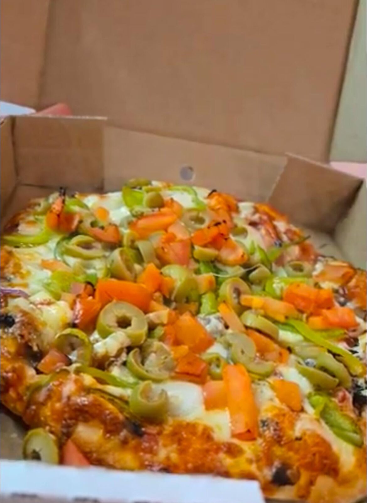 Just a bunch of uncooked toppings on a cooked pizza, no biggie